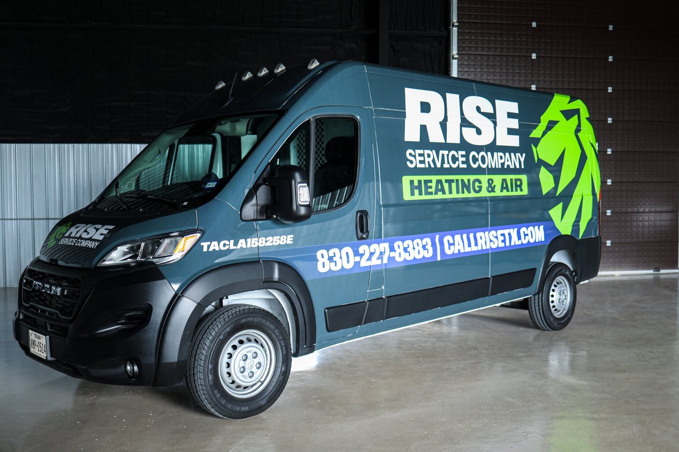 Wrapped Rise Service Company RAM van at the shop