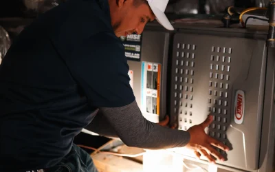 Rise Service Company technician working on an HVAC system in the attic